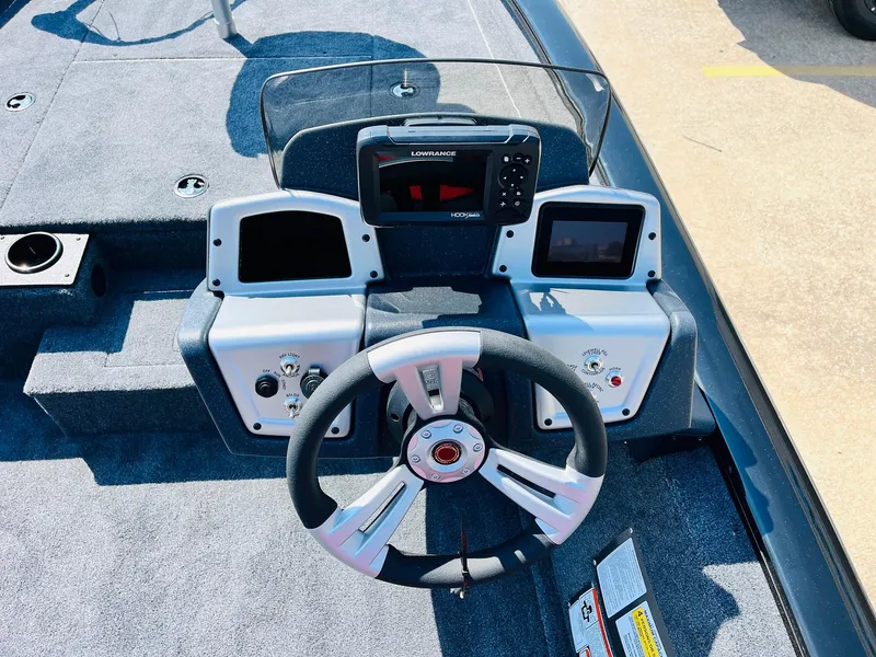 Slide: The Image of 2025 Tracker Pro Team 175 boat dashboard with steering wheel and electronic displays. - 24
