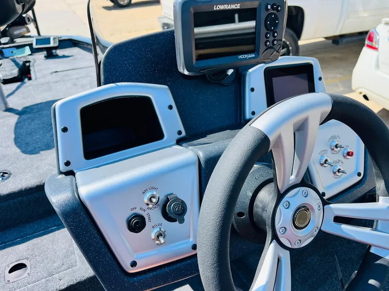 Slide: The Image of 2025 Tracker Pro Team 175 boat dashboard with steering wheel and electronic displays. - 25