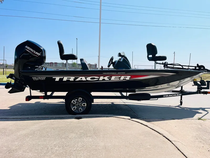 Slide: The Image of 2025 Tracker Pro Team 175 boat with Mercury engine, parked on a trailer. - 3
