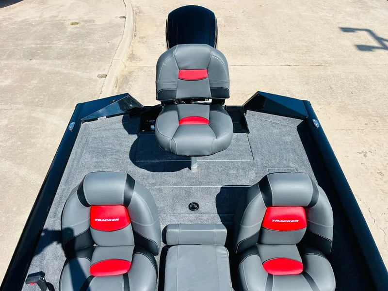 Slide: The Image of 2025 Tracker Pro Team 175 boat interior with gray and red seating. - 30