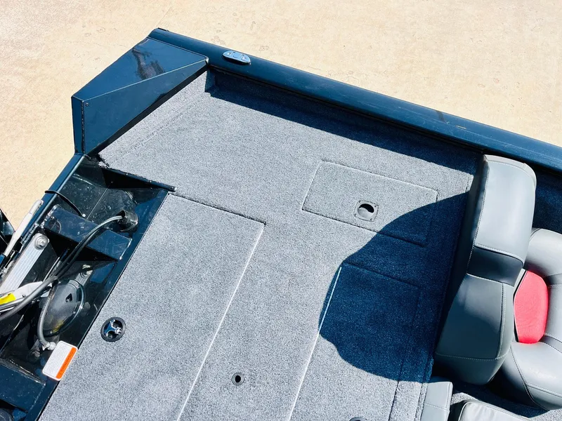 Slide: The Image of 2025 Tracker Pro Team 175 boat interior with gray carpet and seating. - 34