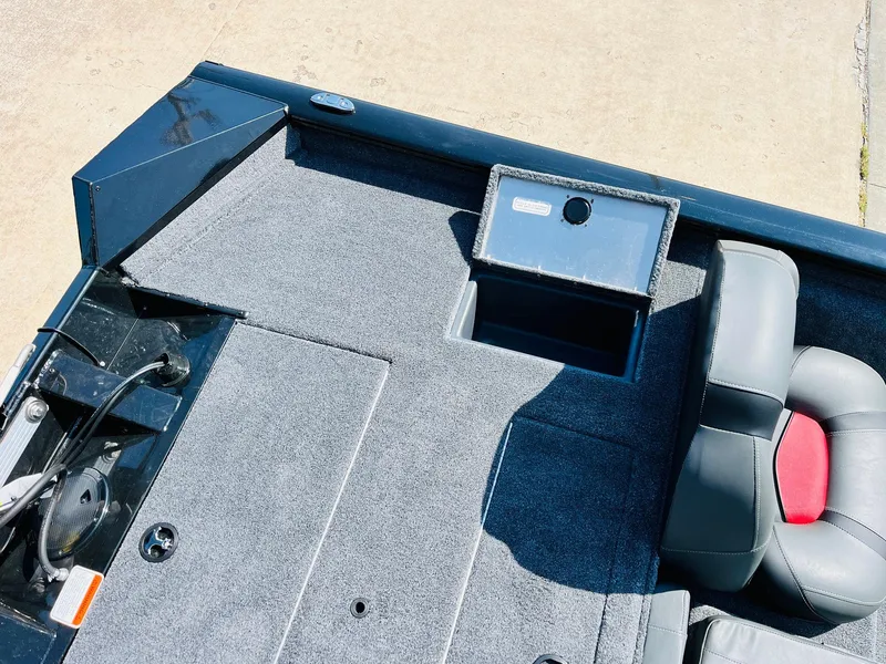 Slide: The Image of 2025 Tracker Pro Team 175 boat interior with gray carpet and seating. - 35