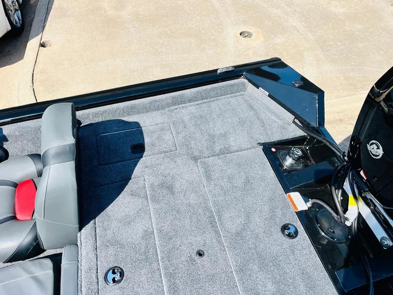 Slide: The Image of 2025 Tracker Pro Team 175 boat interior with gray carpet and seating. - 37