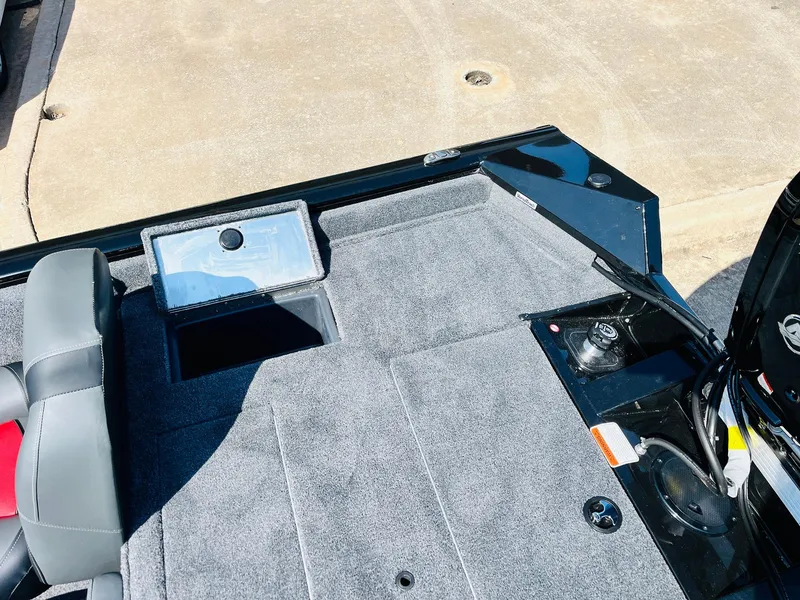 Slide: The Image of 2025 Tracker Pro Team 175 boat interior with gray carpet and storage compartments. - 38