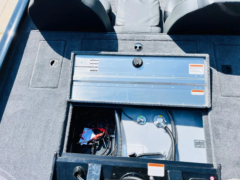 Slide: The Image of 2025 Tracker Pro Team 175 boat interior with open storage compartment. - 40