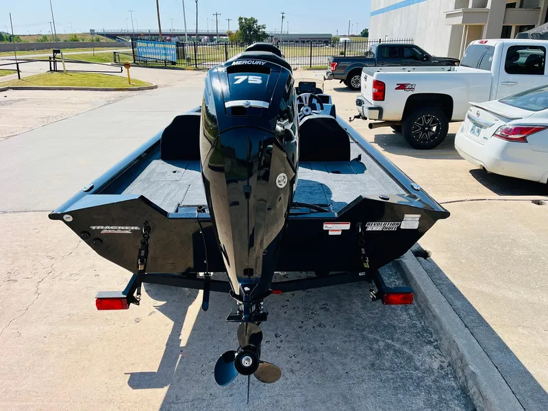 Slide: The Image of 2025 Tracker Pro Team 175 boat with Mercury 75 engine, parked outdoors. - 5