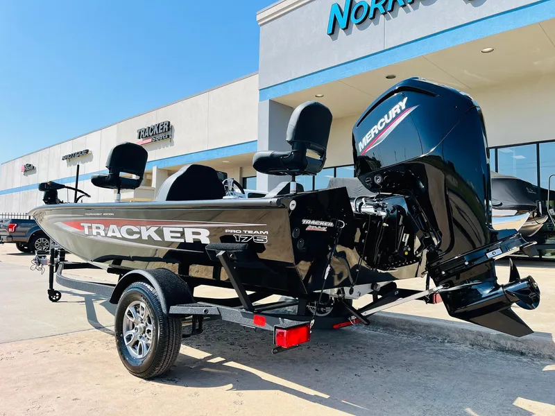Slide: The Image of 2025 Tracker Pro Team 175 boat with Mercury engine, parked outside dealership. - 6