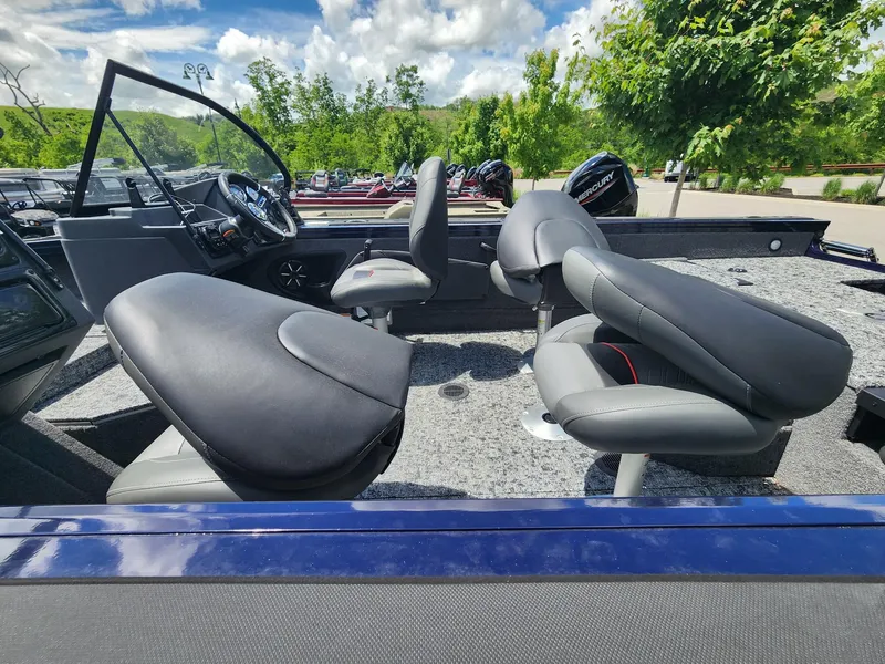 Slide: The Image of 2025 Tracker Targa V-18 Combo boat interior with plush seating and modern dashboard. - 4