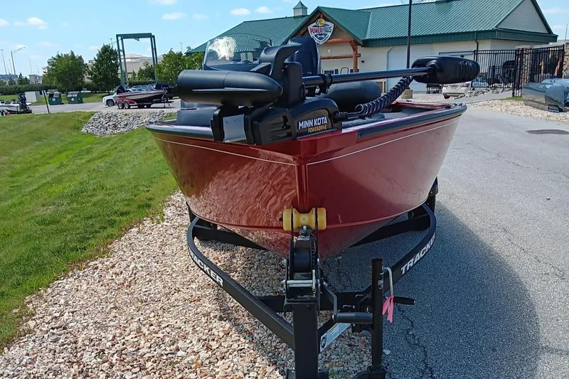 Slide: The Image of 2025 Tracker Super Guide V-16 SC boat on trailer, parked outdoors. - 2