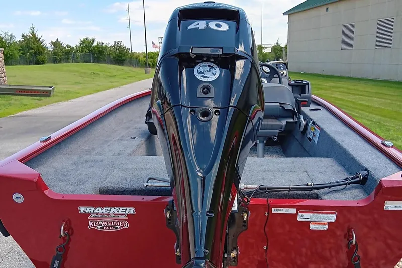 Slide: The Image of 2025 Tracker Super Guide V-16 SC boat with 40 HP outboard motor, red exterior. - 3