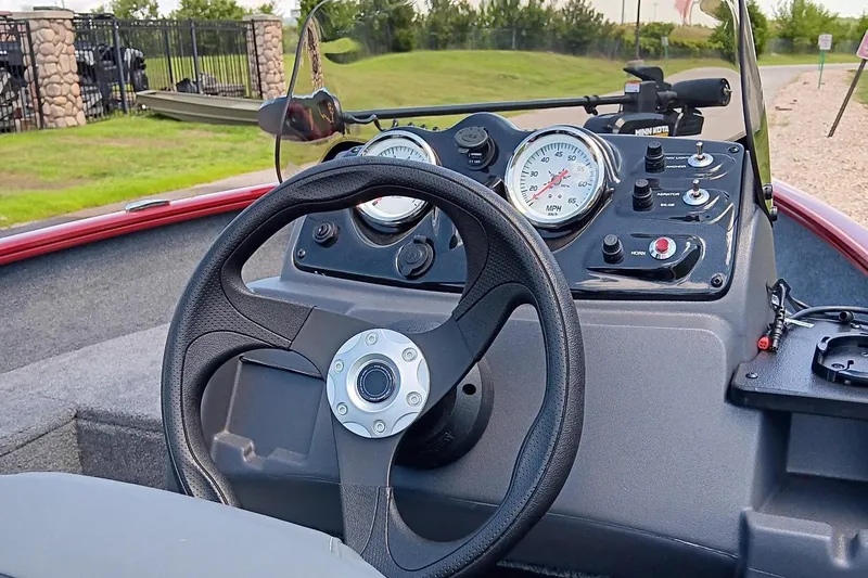Slide: The Image of 2025 Tracker Super Guide V-16 SC boat dashboard with steering wheel and gauges. - 5