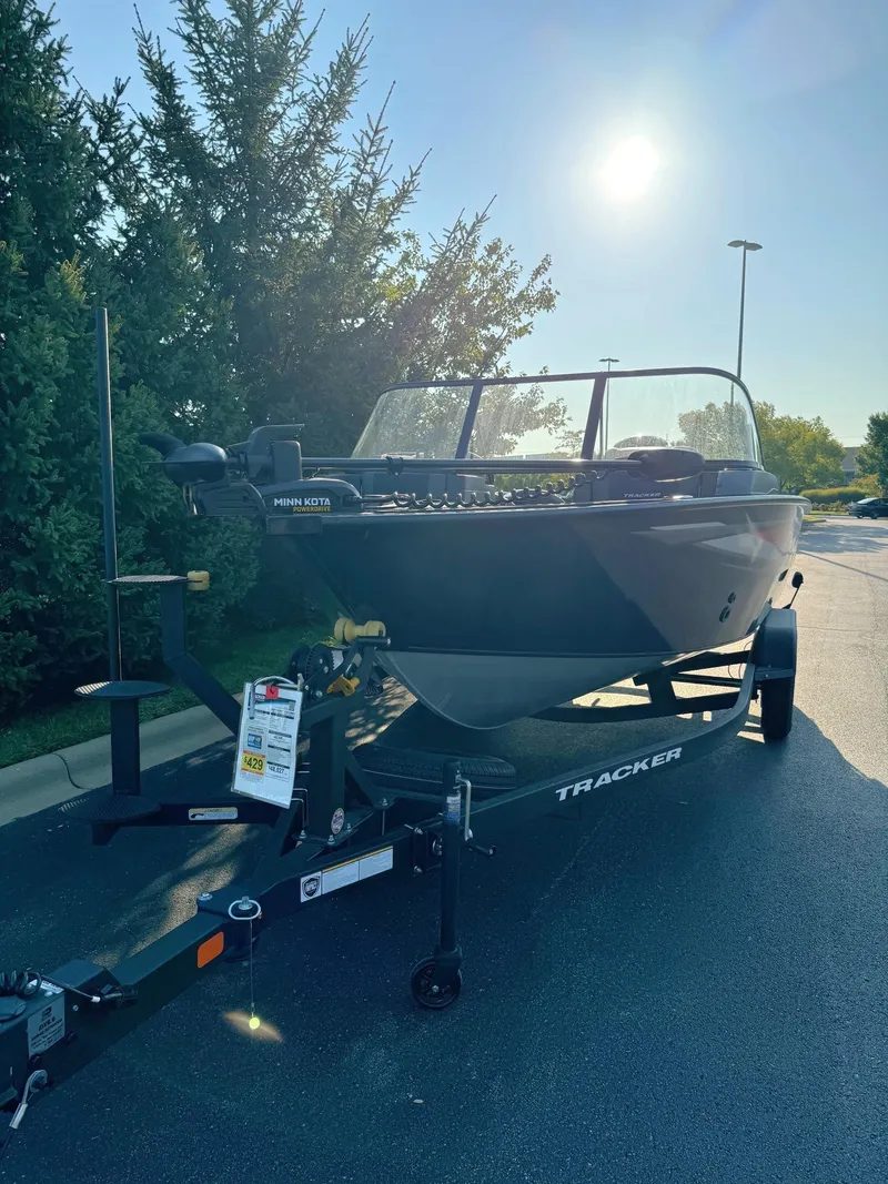 Slide: The Image of 2025 Tracker Targa V-18 Combo boat on trailer, parked outdoors. - 2