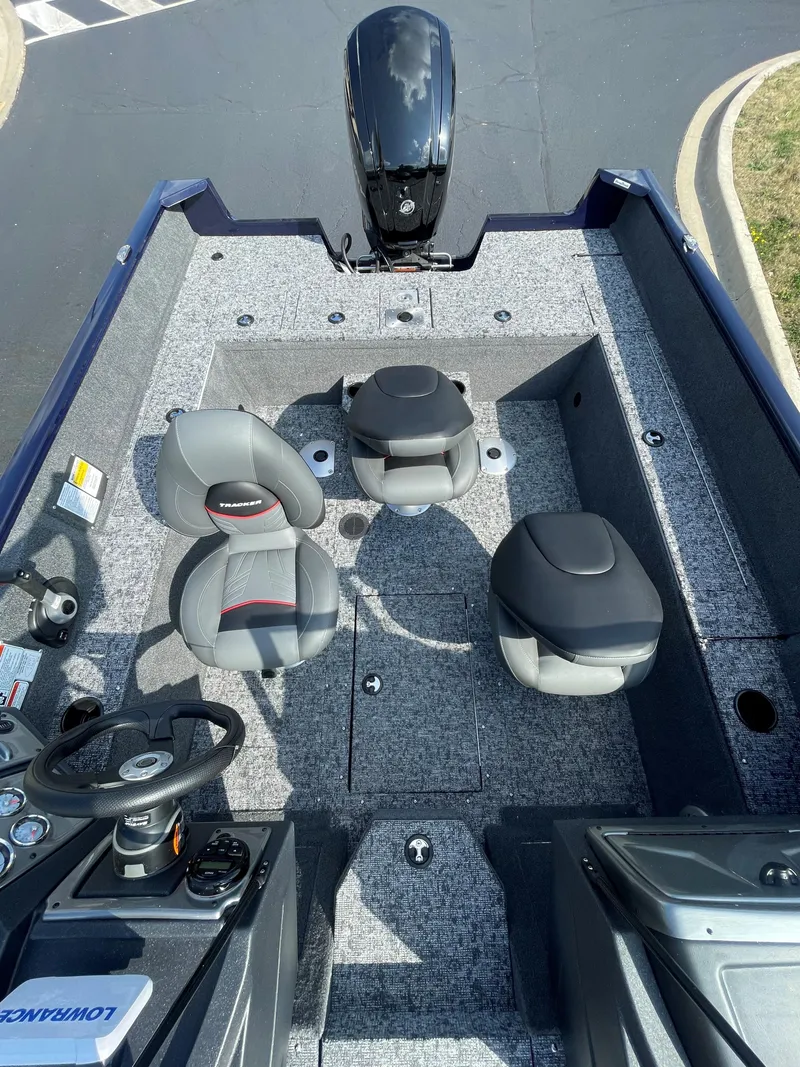 Slide: The Image of 2025 Tracker Pro Guide V-175 WT boat interior with seating and steering console. - 2