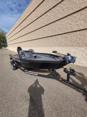 Slide: The Image of 2025 Tracker Super Guide V-16 SC fishing boat on trailer, parked outdoors. - 4