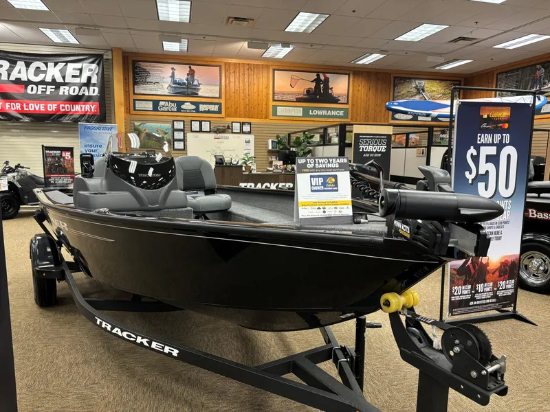 Slide: The Image of 2025 Tracker Super Guide V-16 SC boat displayed in showroom with promotional signage. - 3