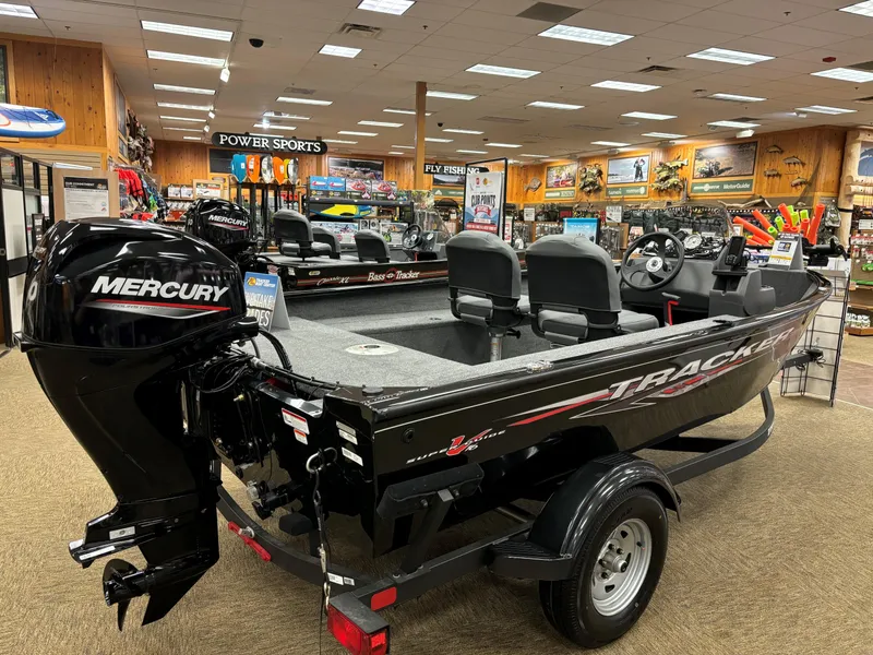 Slide: The Image of 2025 Tracker Super Guide V-16 SC boat with Mercury engine in showroom. - 4