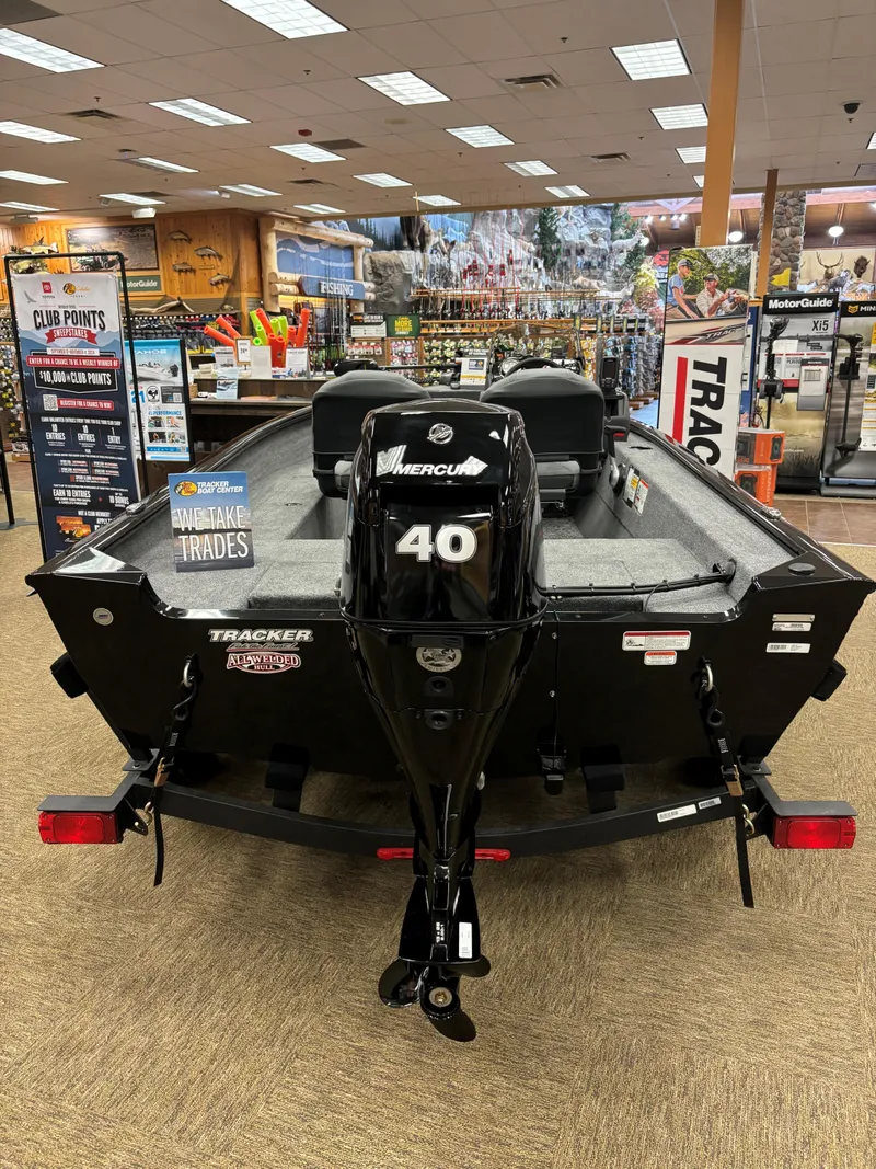 Slide: The Image of 2025 Tracker Super Guide V-16 SC boat with Mercury 40 engine in showroom. - 5