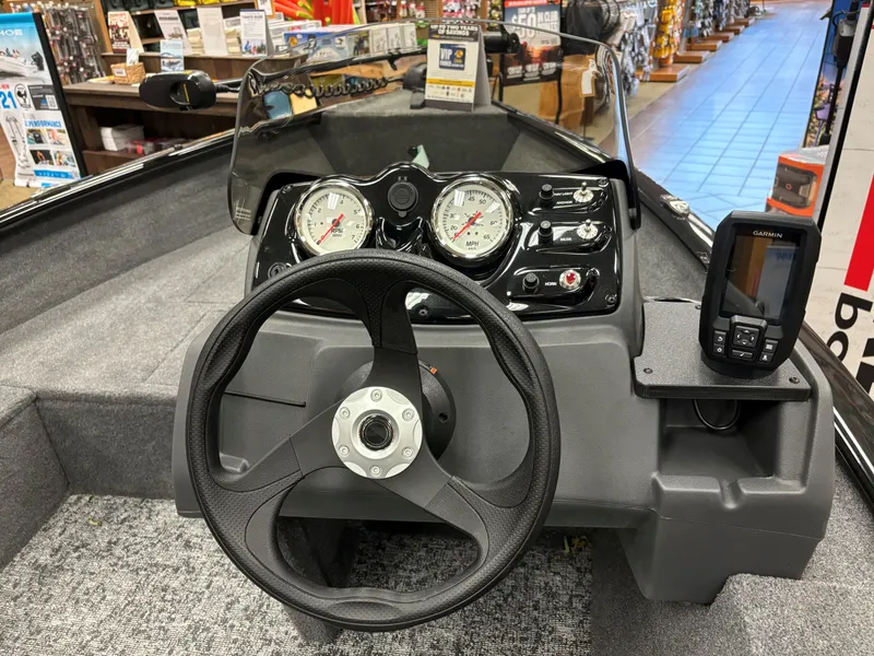 Slide: The Image of 2025 Tracker Super Guide V-16 SC boat dashboard with steering wheel and gauges. - 6