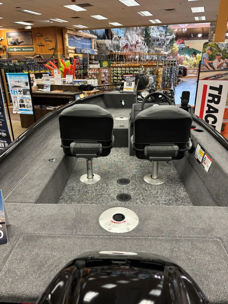 Slide: The Image of 2025 Tracker Super Guide V-16 SC fishing boat displayed in a showroom. - 8