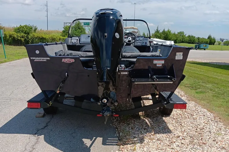 Slide: The Image of 2025 Tracker Pro Guide V-175 WT boat on trailer, rear view, parked outdoors. - 3