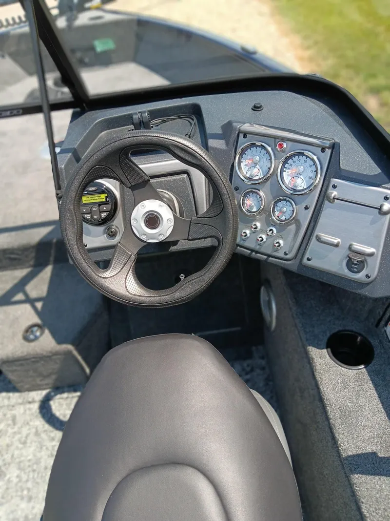 Slide: The Image of 2025 Tracker Pro Guide V-175 WT boat dashboard with steering wheel and gauges. - 4