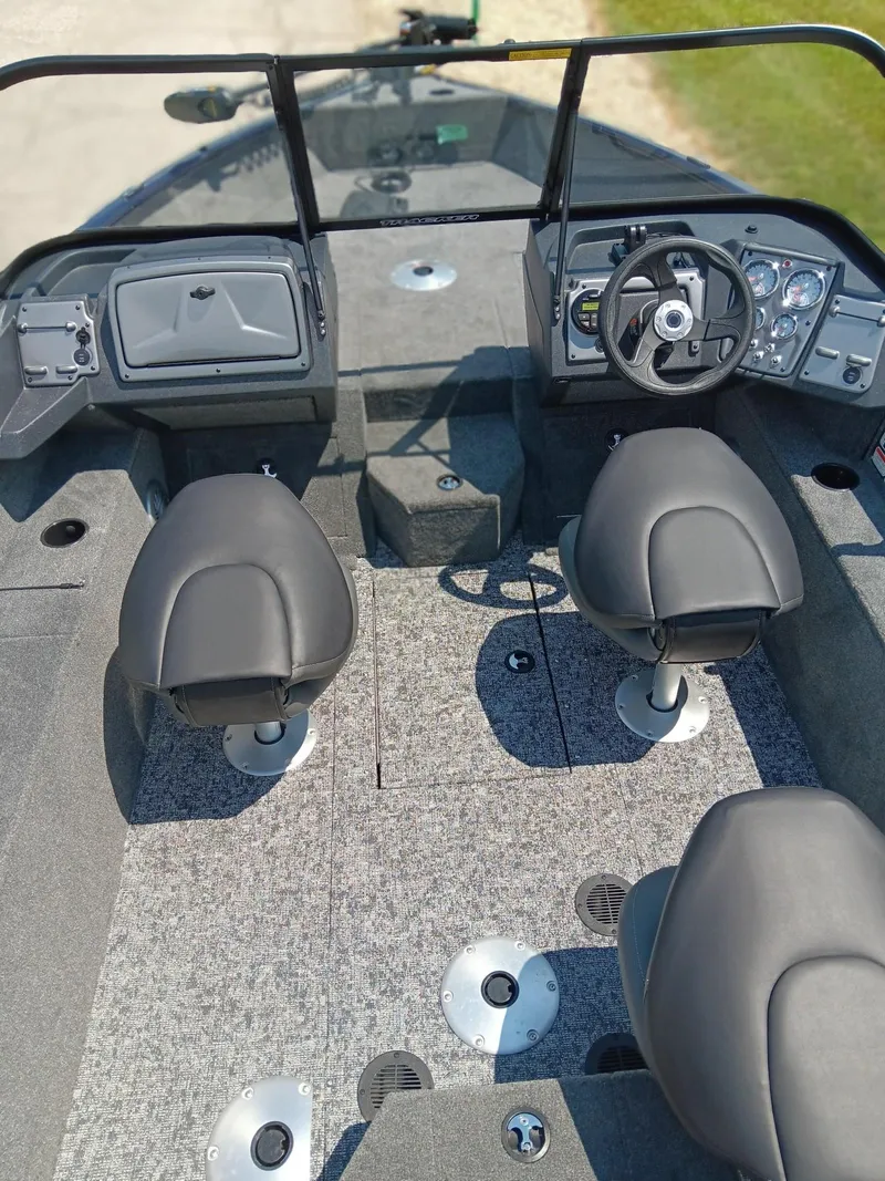 Slide: The Image of 2025 Tracker Pro Guide V-175 WT boat interior with dual seats and steering console. - 6