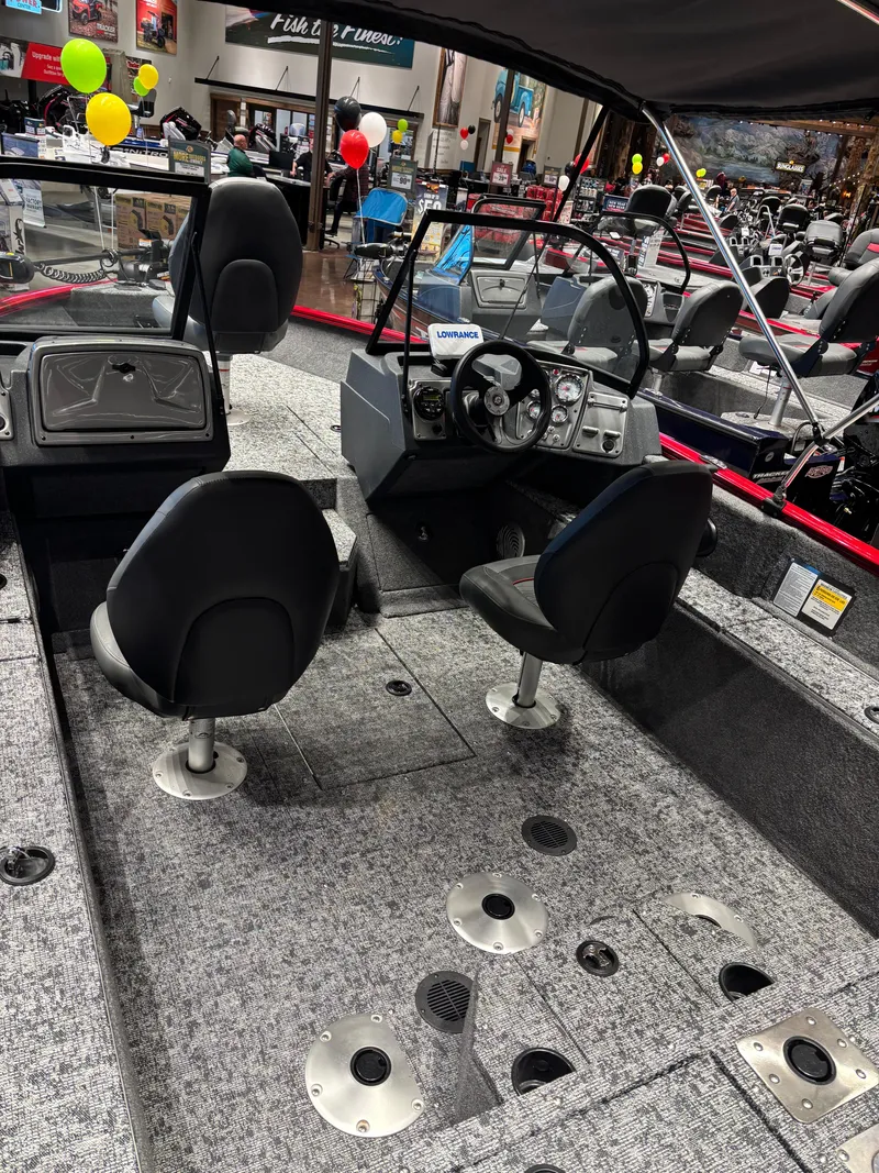 Slide: The Image of 2025 Tracker Pro Guide V-175 WT boat interior with seating and steering console. - 3
