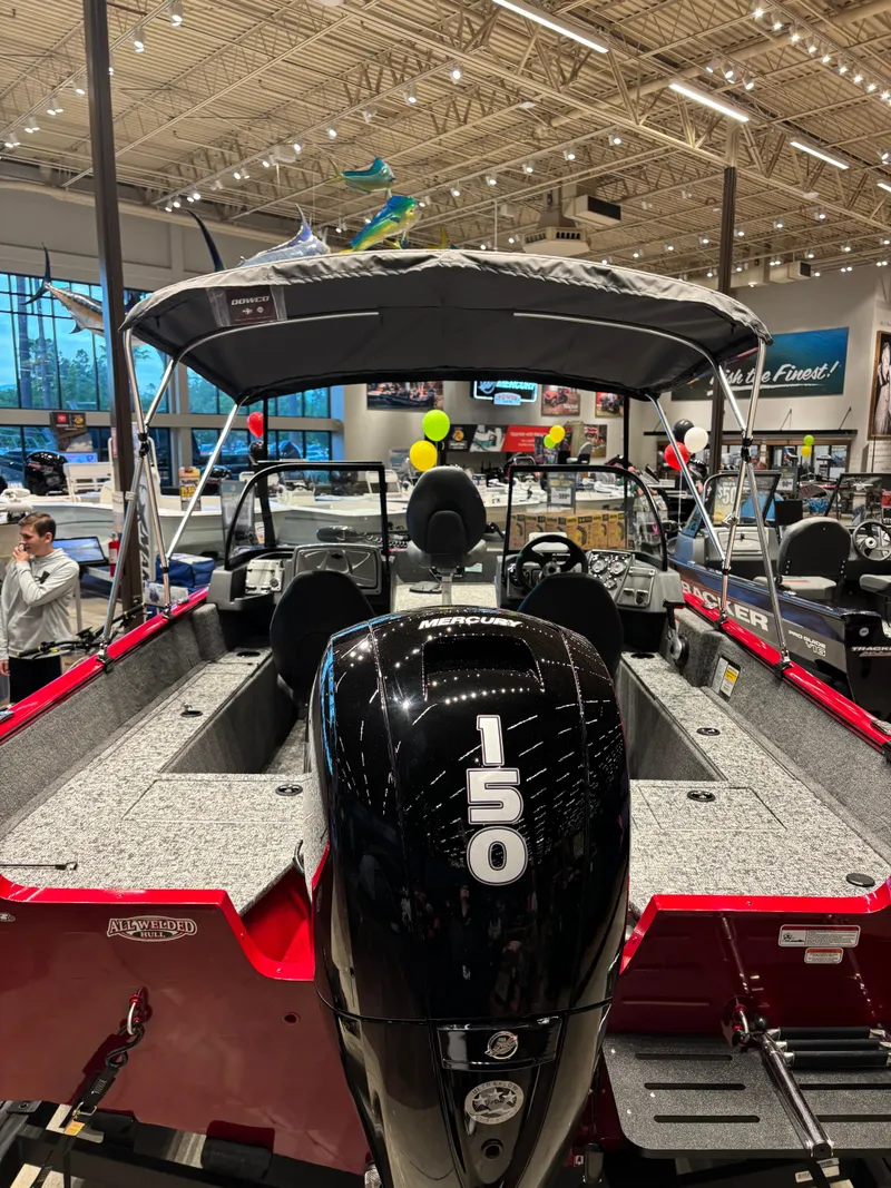 Slide: The Image of 2025 Tracker Pro Guide V-175 WT boat with 150 HP engine displayed indoors. - 4