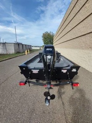 Slide: The Image of 2025 Tracker Super Guide V-16 SC boat on trailer, rear view, outdoors. - 4