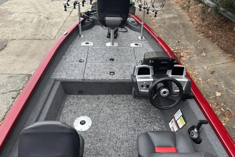 Slide: The Image of 2025 Tracker Pro Team 175 Crappie Edition boat interior with steering wheel and fishing rod holders. - 85