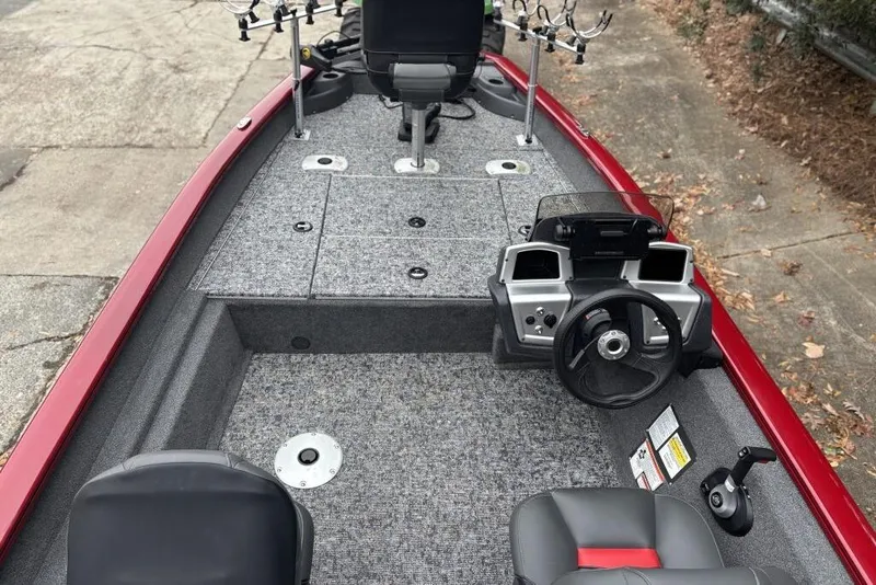 Slide: The Image of 2025 Tracker Pro Team 175 Crappie Edition boat interior with steering console and fishing rod holders. - 93