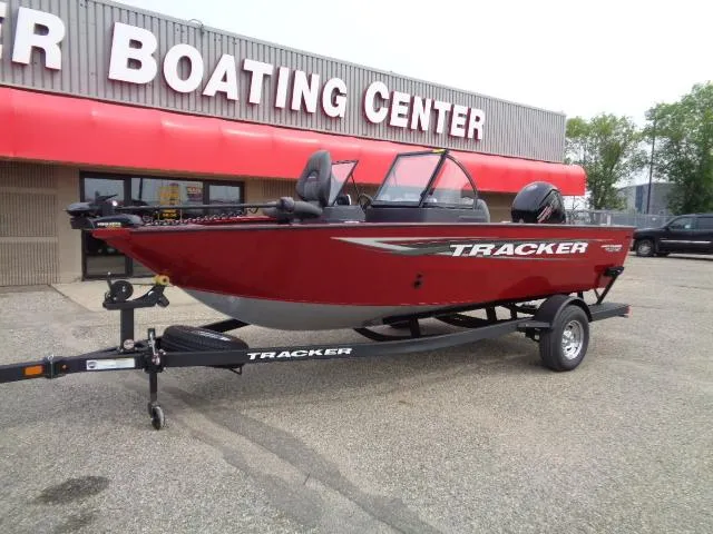 Slide: The Image of 2025 Tracker Pro Guide V-175 WT boat displayed at a boating center. - 2