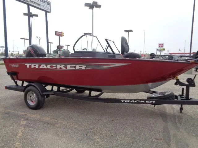 Slide: The Image of 2025 Tracker Pro Guide V-175 WT boat on trailer, red exterior, parked outdoors. - 3