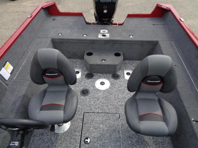 Slide: The Image of 2025 Tracker Pro Guide V-175 WT boat interior with two seats and carpeted flooring. - 7