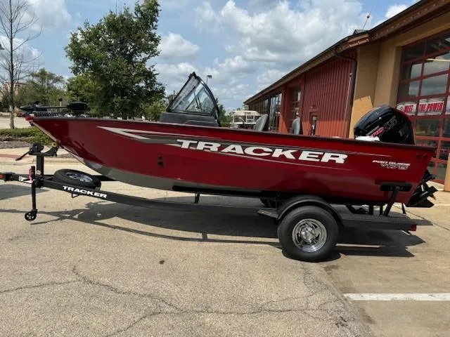 Slide: The Image of 2025 Tracker Pro Guide V-175 WT boat on trailer, red exterior, parked outdoors. - 3