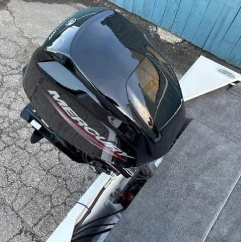 Slide: The Image of 2025 Tracker Bass Tracker Classic XL with Mercury outboard motor on pavement. - 16