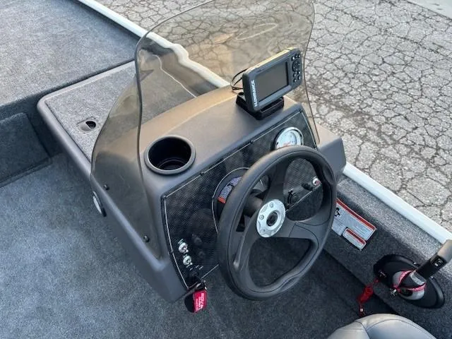 Slide: The Image of 2025 Tracker Bass Tracker Classic XL boat console with steering wheel and fish finder. - 8