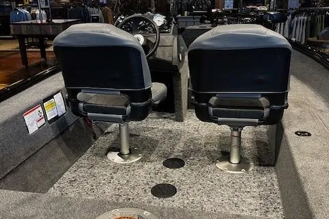 Slide: The Image of 2025 Tracker Super Guide V-16 SC boat interior with dual seats and steering console. - 2