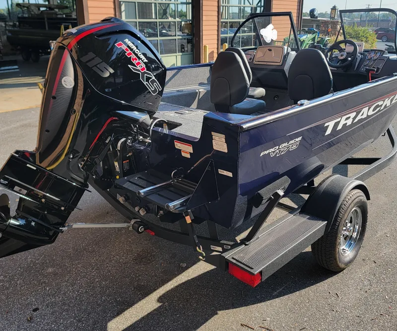 Slide: The Image of 2025 Tracker Pro Guide V-175 WT boat with powerful outboard motor on trailer. - 2
