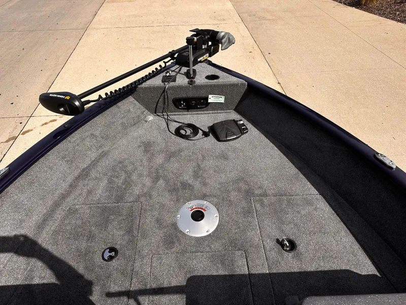 Slide: The Image of 2025 Tracker Pro Guide V-175 WT boat deck with trolling motor and carpeted surface. - 3