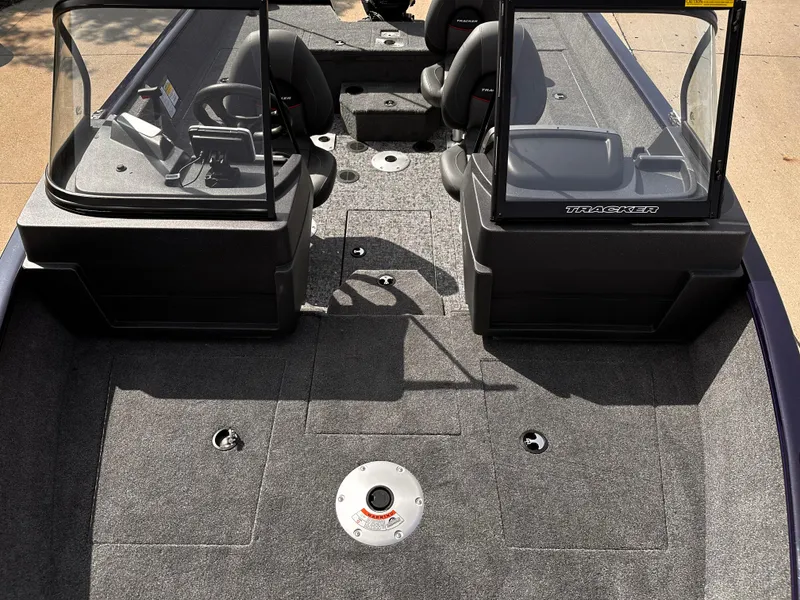 Slide: The Image of 2025 Tracker Pro Guide V-175 WT boat interior with dual consoles and carpeted deck. - 4