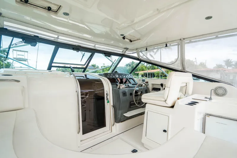 Slide: The Image of 1995 Tiara Yachts 4300 Open interior with helm and seating area. - 11