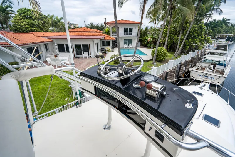 Slide: The Image of Tiara Yachts 1995 4300 Open helm with waterfront view and tropical setting. - 18