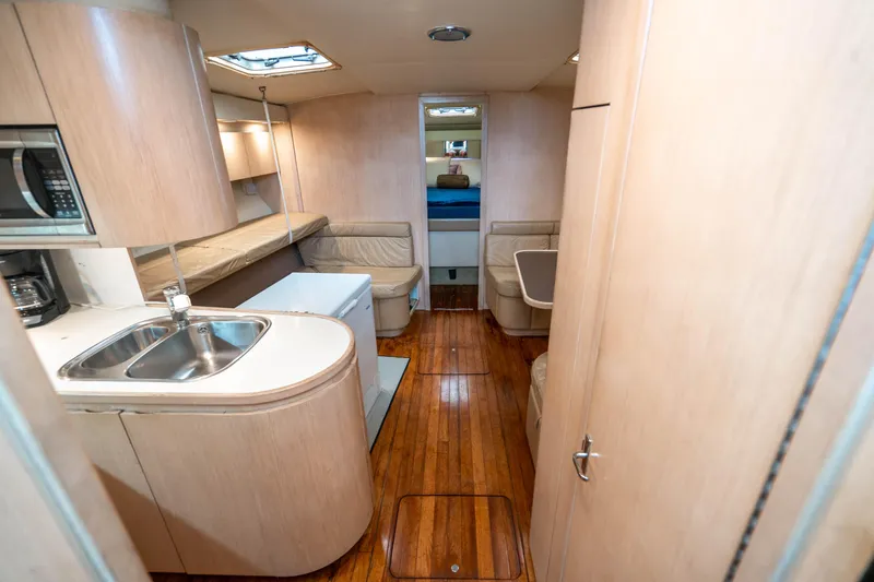 Slide: The Image of Interior of 1995 Tiara Yachts 4300 Open with wood flooring and modern amenities. - 21