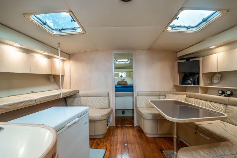 Slide: The Image of 1995 Tiara Yachts 4300 Open interior with seating, table, and skylights. - 28