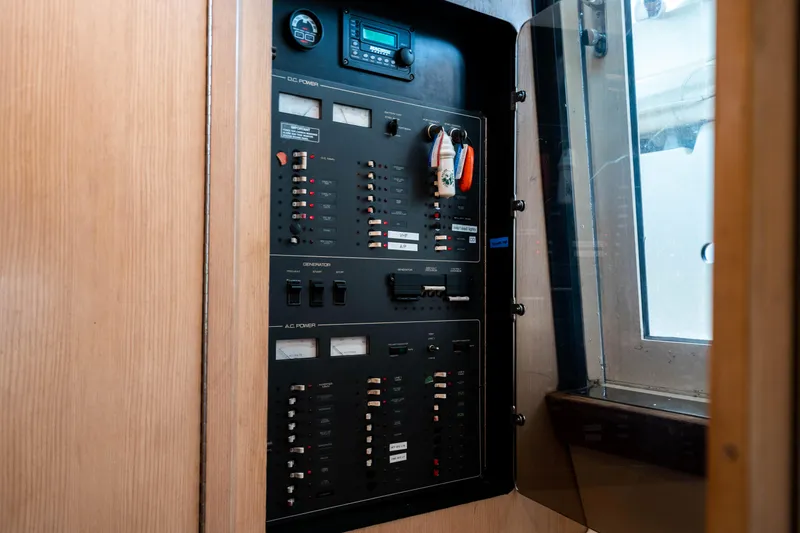 Slide: The Image of Electrical panel inside a 1995 Tiara Yachts 4300 Open, featuring various switches and controls. - 29