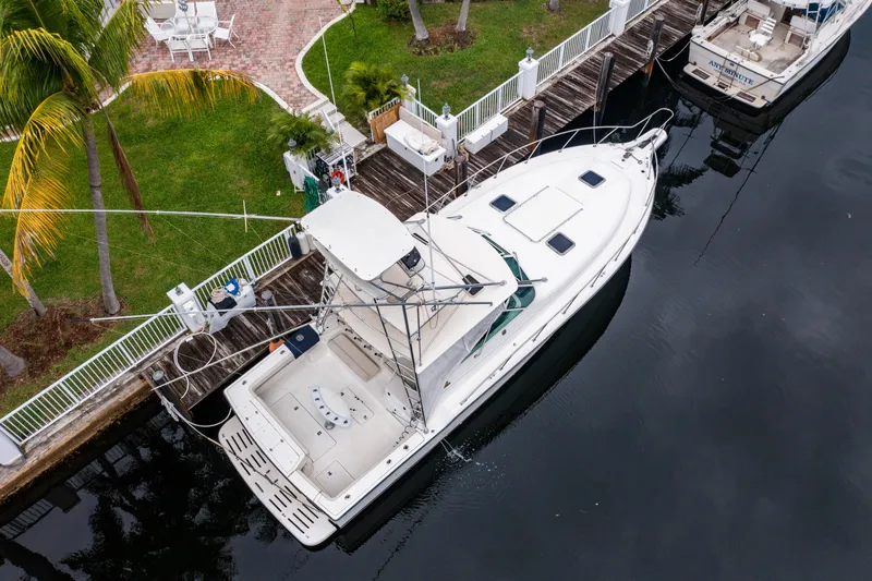 Slide: The Image of Aerial view of 1995 Tiara Yachts 4300 Open docked by a waterfront. - 3