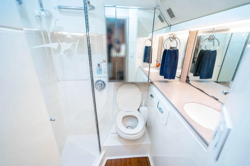 Slide: The Image of Bathroom interior of 1995 Tiara Yachts 4300 Open, featuring toilet, sink, and mirror. - 32