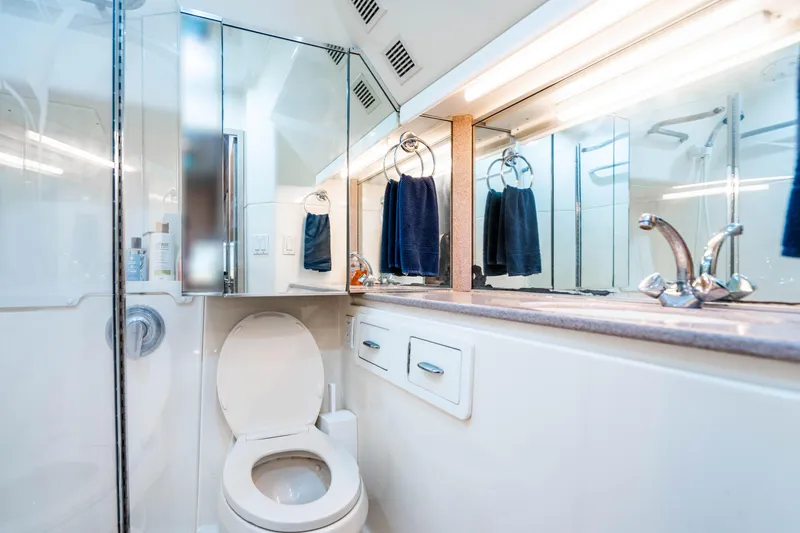Slide: The Image of Bathroom interior of 1995 Tiara Yachts 4300 Open, featuring modern fixtures and mirrors. - 33