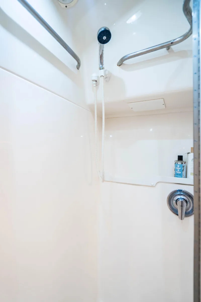 Slide: The Image of Shower area in 1995 Tiara Yachts 4300 Open, featuring sleek white design and modern fixtures. - 34